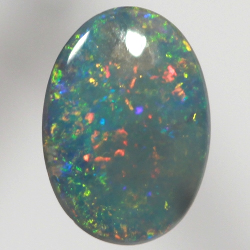 SOLID BLACK OPAL Sparkling reds, yellows over ocean blue